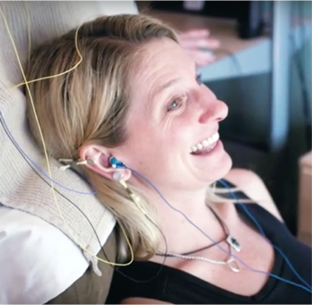 picture of happy women client receiving neurofeedback smiling picture of happy women client receiving neurofeedback smiling